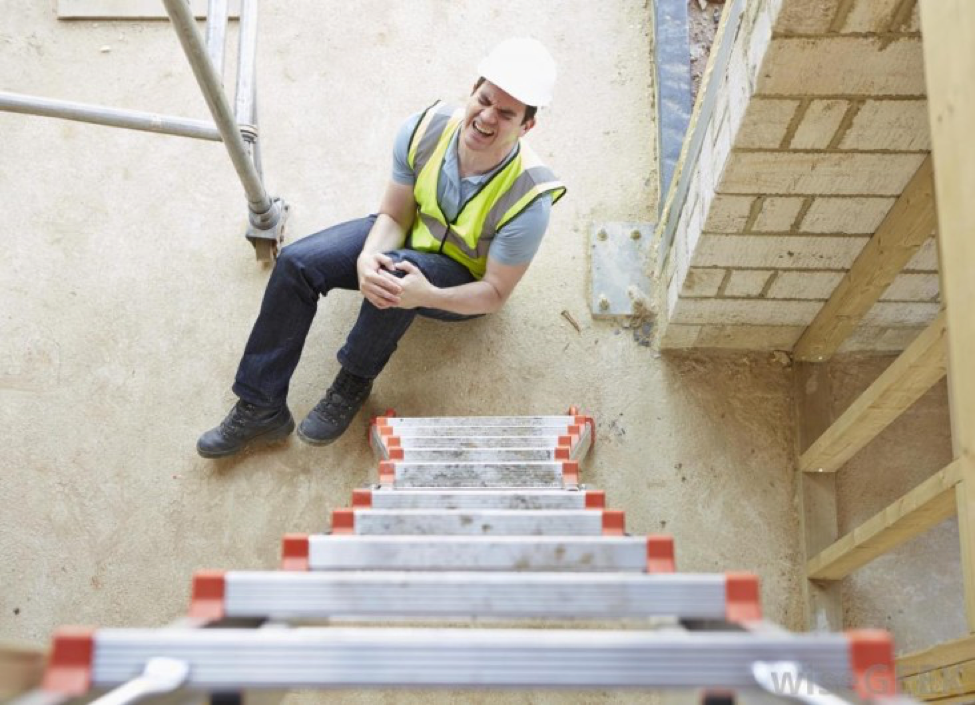 construction work at bottom of ladder holding knee | work accident lawyer