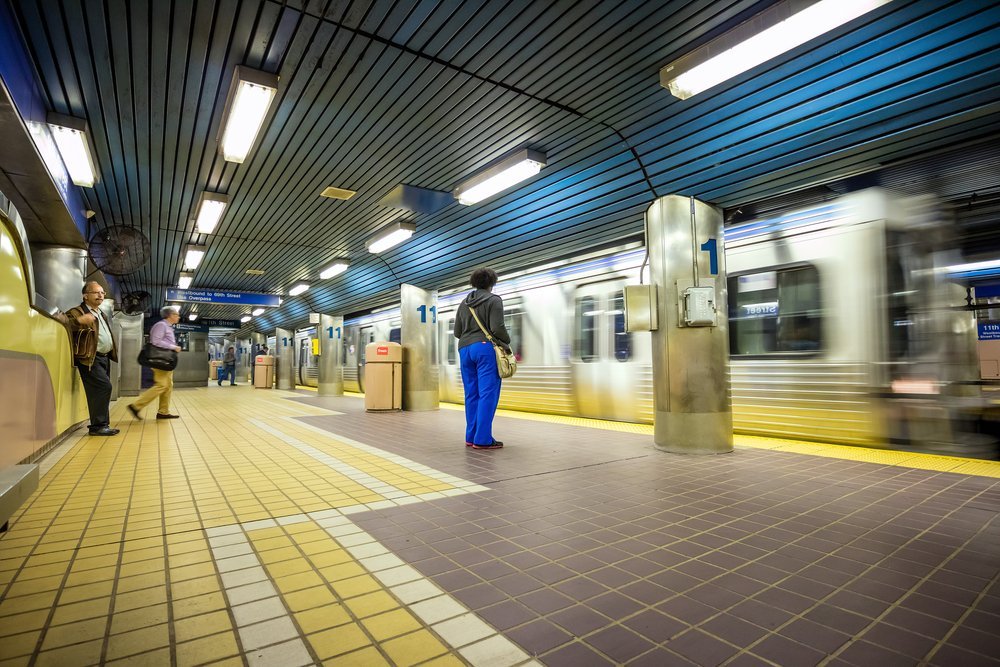 three people waiting on subway train | public transit injury attorney