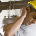 construction worker holding neck | work injury attorney