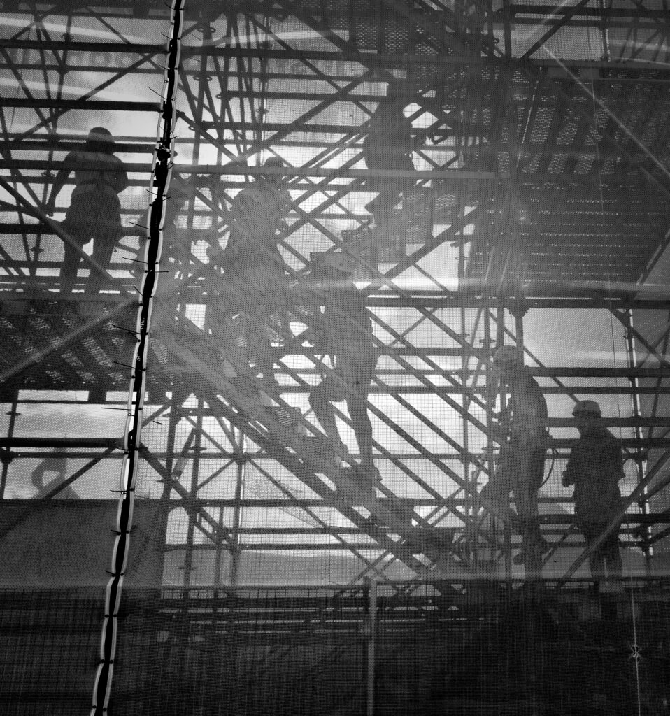 seven men on stairs at construction site | Work injury attorney