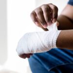 man wrapping bandage around hand | personal injury attorney