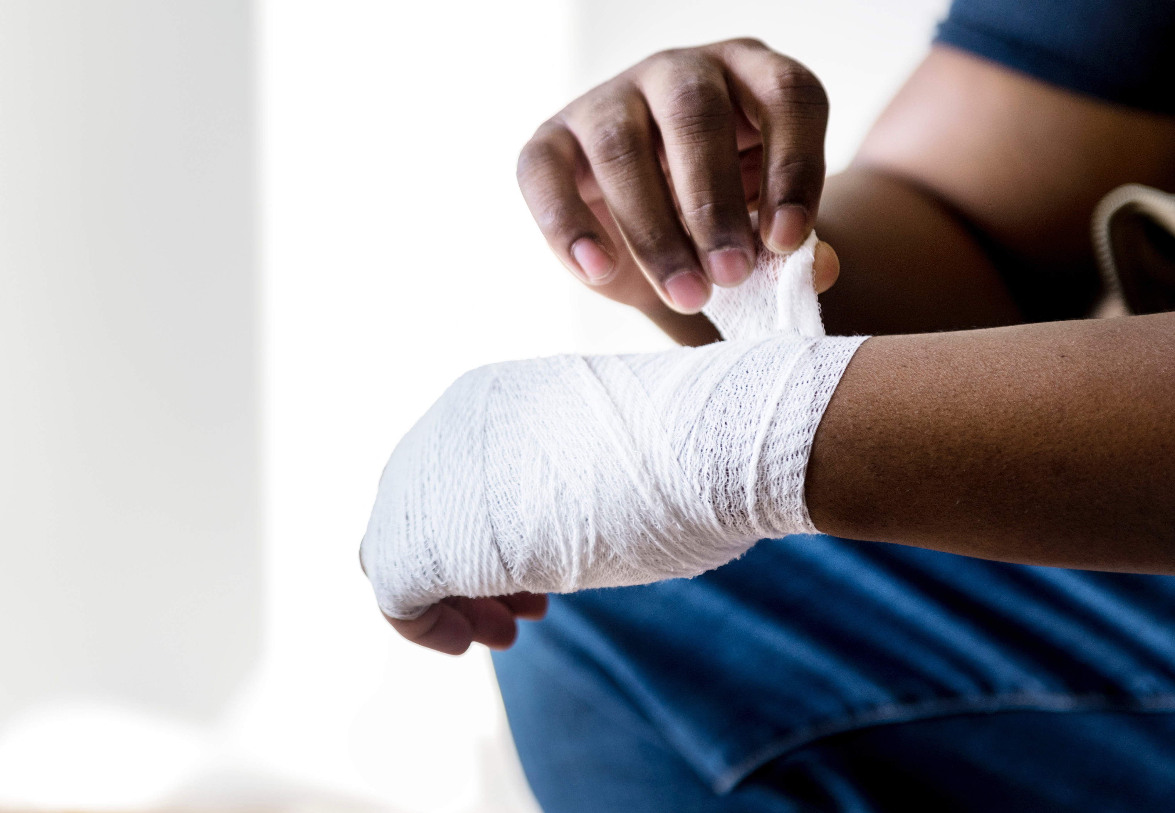 man wrapping bandage around hand | personal injury attorney