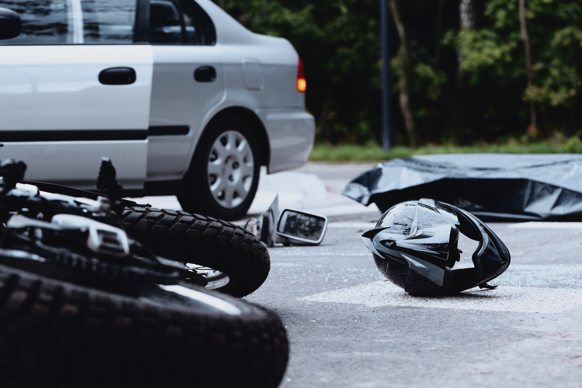 motorcyle and helmet on ground after accident | car accident lawyer