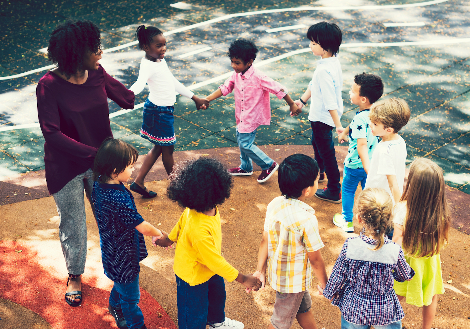 children holding hands in circle | daycare injury attorney